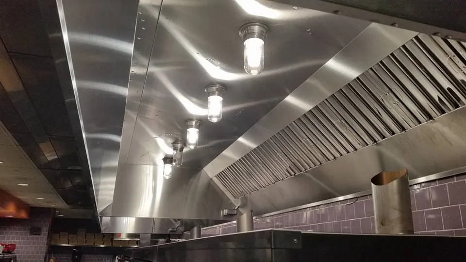 Best Hood Cleaning technician inspecting and cleaning a commercial kitchen exhaust system in Sacramento